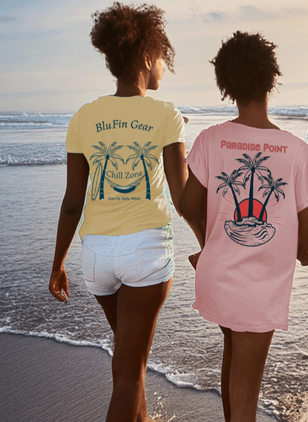 Two people on a beach wearing t-shirts with palm tree designs.