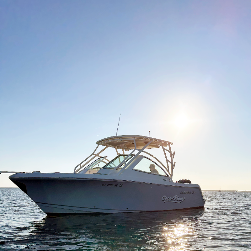 White boat on calm water with a clear blue sky